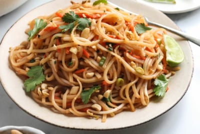 vegan pad thai noodles on a white plate